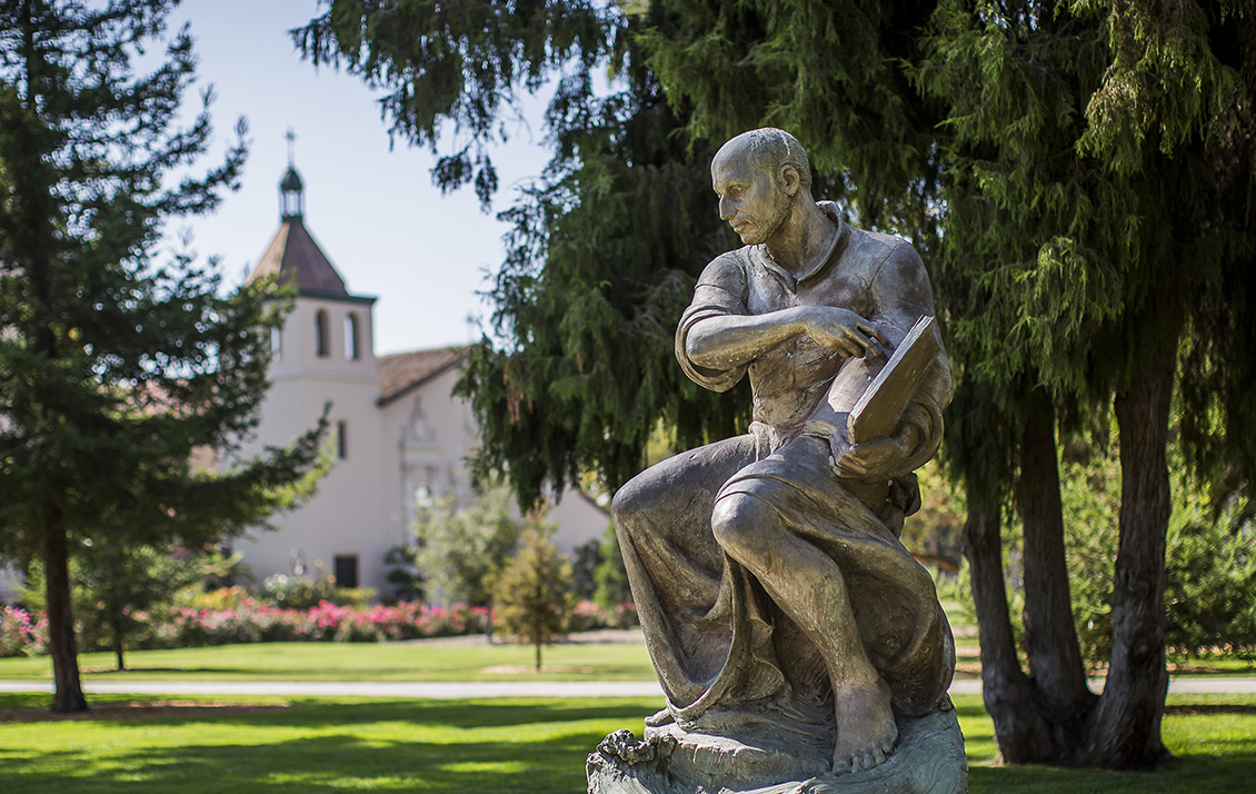 St Ignatius Statue on Santa Claras campus with Mission Church in background.