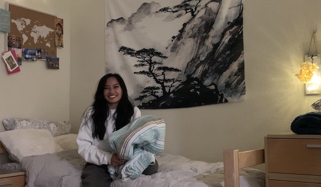 Isabel Andaya 24 holds a favorite blanket  inside her room at Graham Hall.
