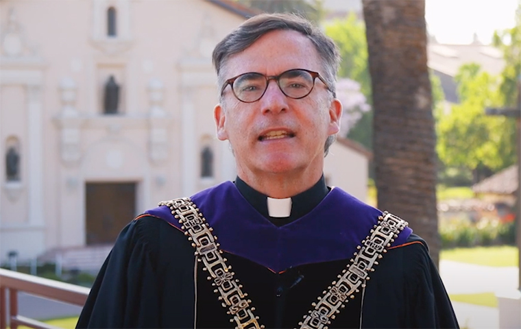 President Kevin OBrien stands in front of the Mission Church in regalia