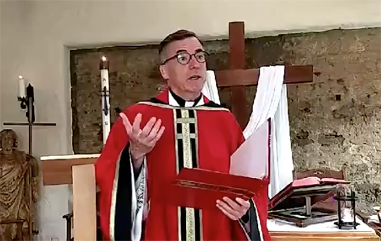 Kevin OBrien, S.J., standing in the St. Francis Chapel