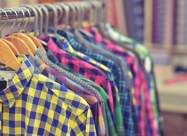 Photo of a rack of colorful mens plaid shirts.