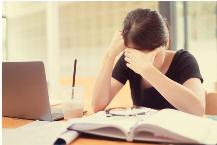 College student looking anguished while studying
