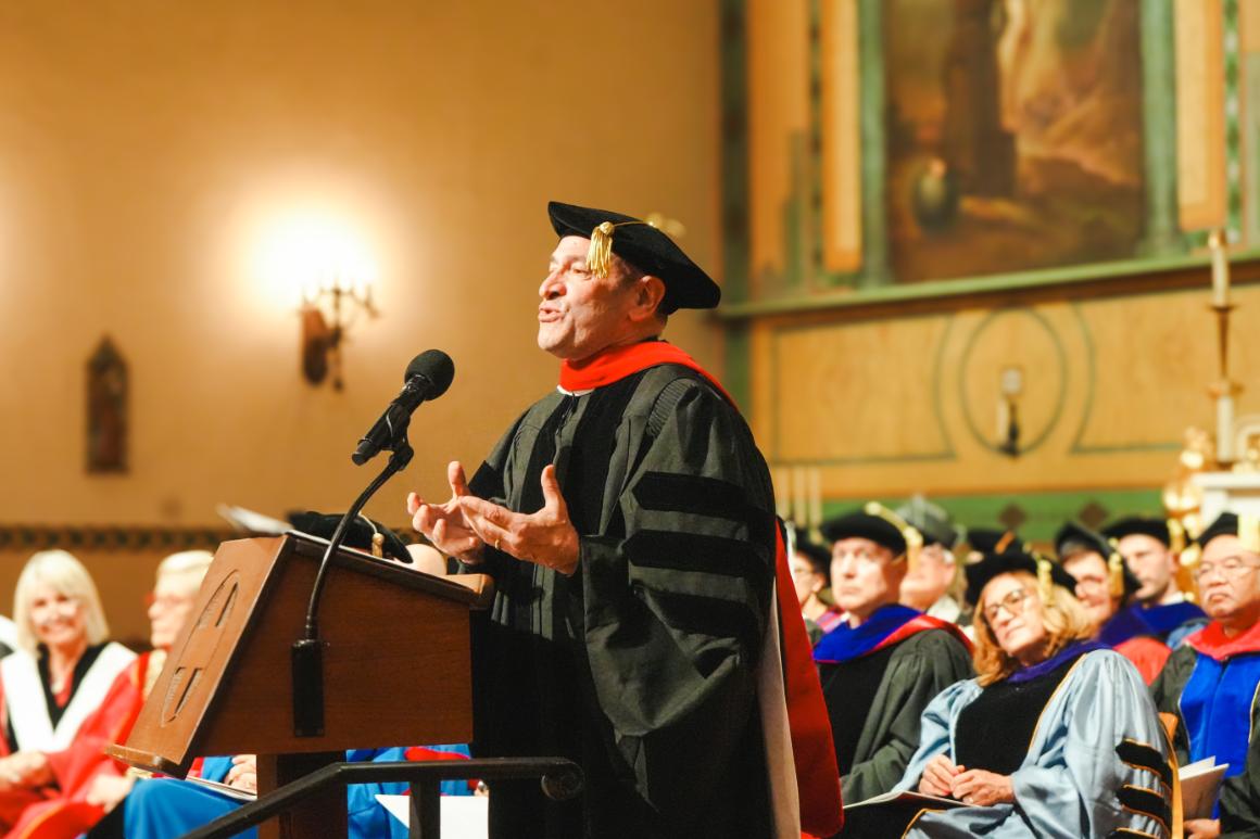 A man speaking at a commencement ceremony