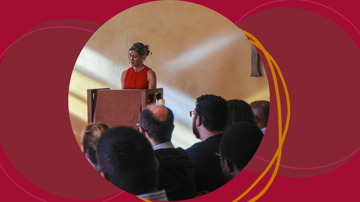 A woman at a lectern on a red background with abstract shapes