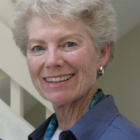 Mary E. McGann, R.S.C.J., Ph.D., smiling in a blue jacket.