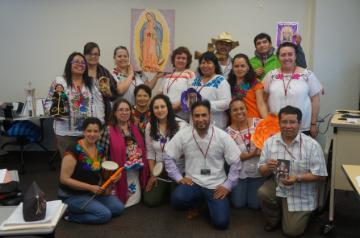 A group photo of people at an educational event indoors.