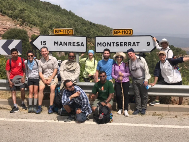 A group of people posing near road signs at Famous and Immersion Experience.