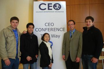 Five people standing in front of a CEO 2010 Conference banner.