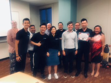 A group of people celebrates the 2019 1st Place Winner.