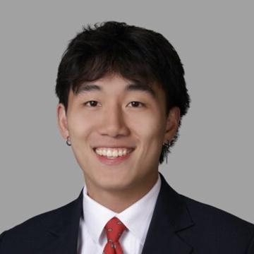 Man in suit with red tie smiling