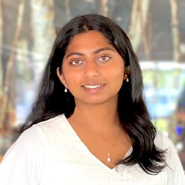 Woman smiling in white top outside