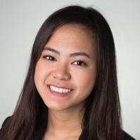 Smiling woman in professional attire against a plain background.