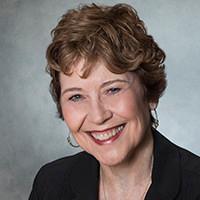 A person smiling in a professional portrait.