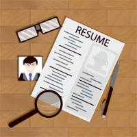 Resume layout with photo, glasses, pen, and magnifying glass on a wooden surface.