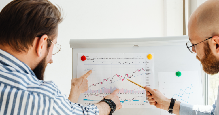 Business professionals analyzing stock performance image link to article