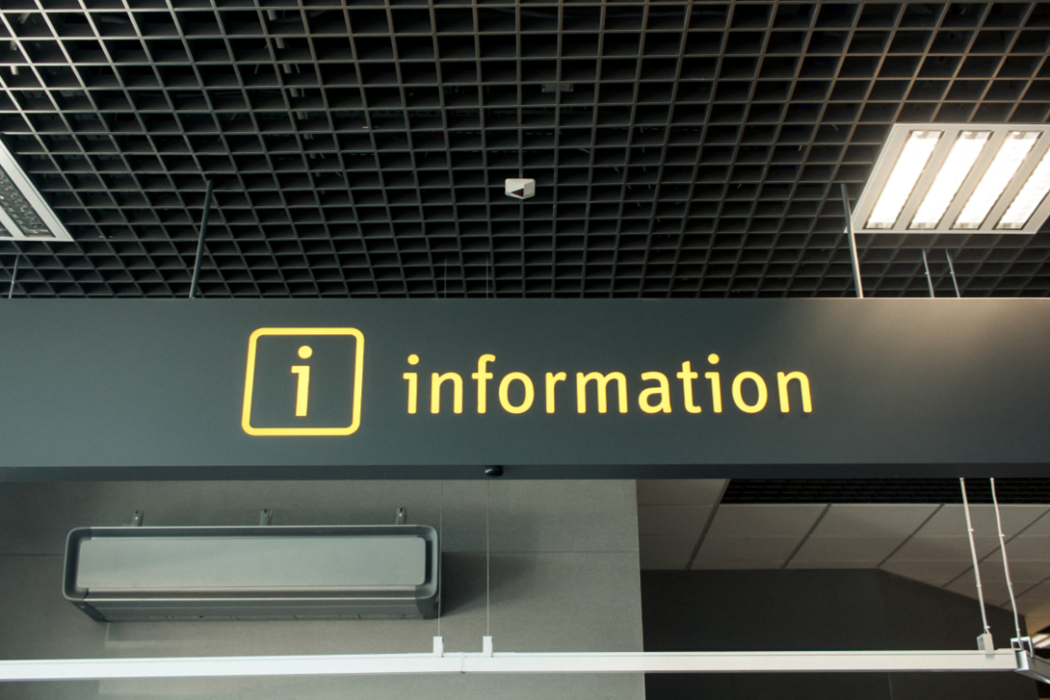 Yellow information sign on a black panel ceiling
