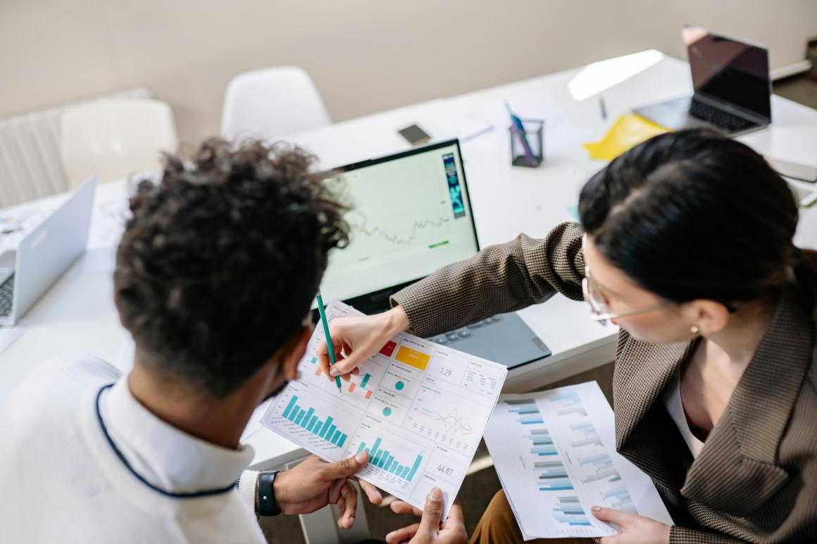 Marketing director discussing charts with colleague