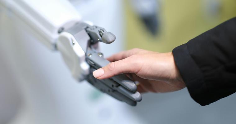 Human and robot handshake closeup