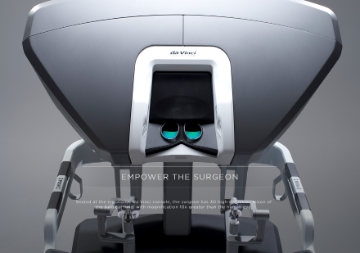 Da Vinci surgical system with robotic arms and a control console.
