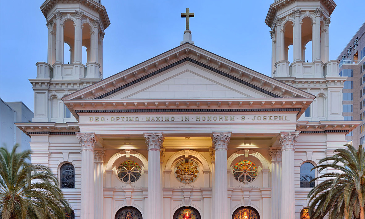 Stately cathedral with twin bell towers and illuminated façade.