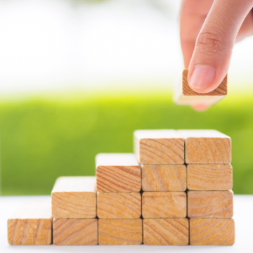 A hand placing building blocks