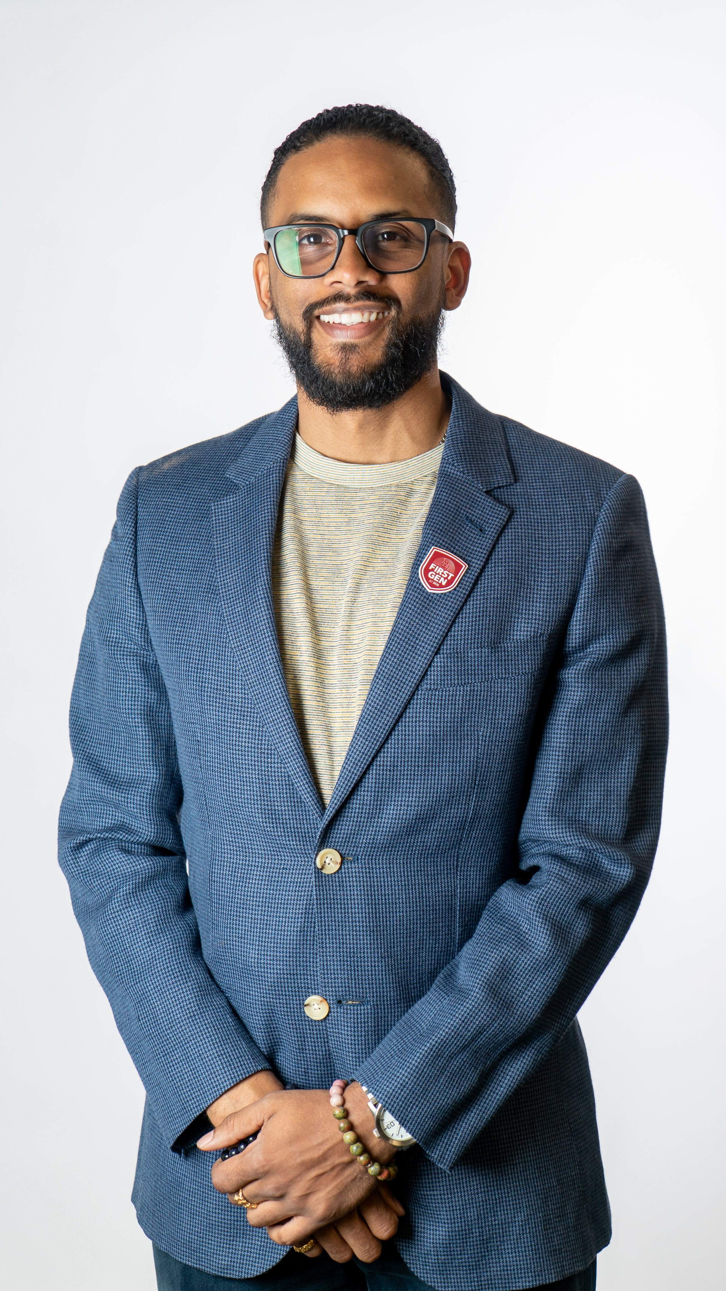 A man in glasses and suit smiling