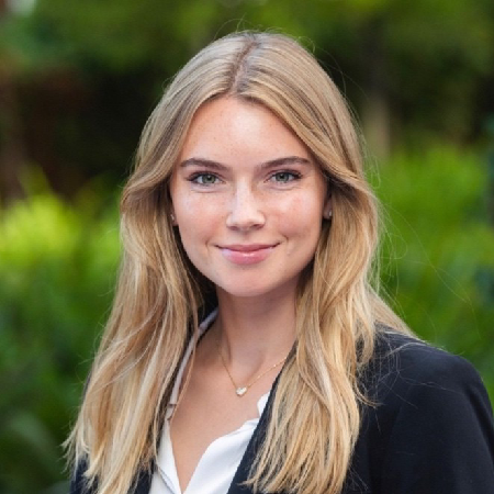 A smiling young woman in business wear.