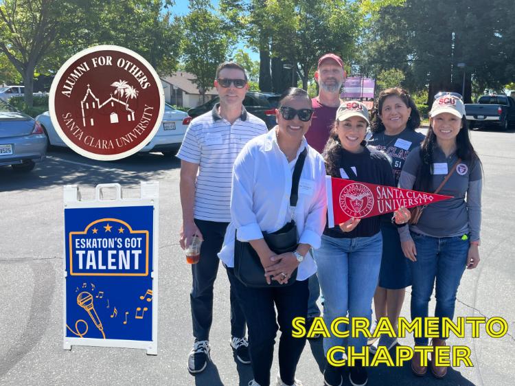 Group of people holding a Santa Clara University pennant. A cutout of a sign reading Eskatons Got Talent as well as yellow lettering reading Sacramento Chapter are overlaid on the image