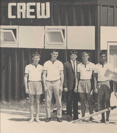 A black and white photo of a group of young men in front of a building labeled Crew