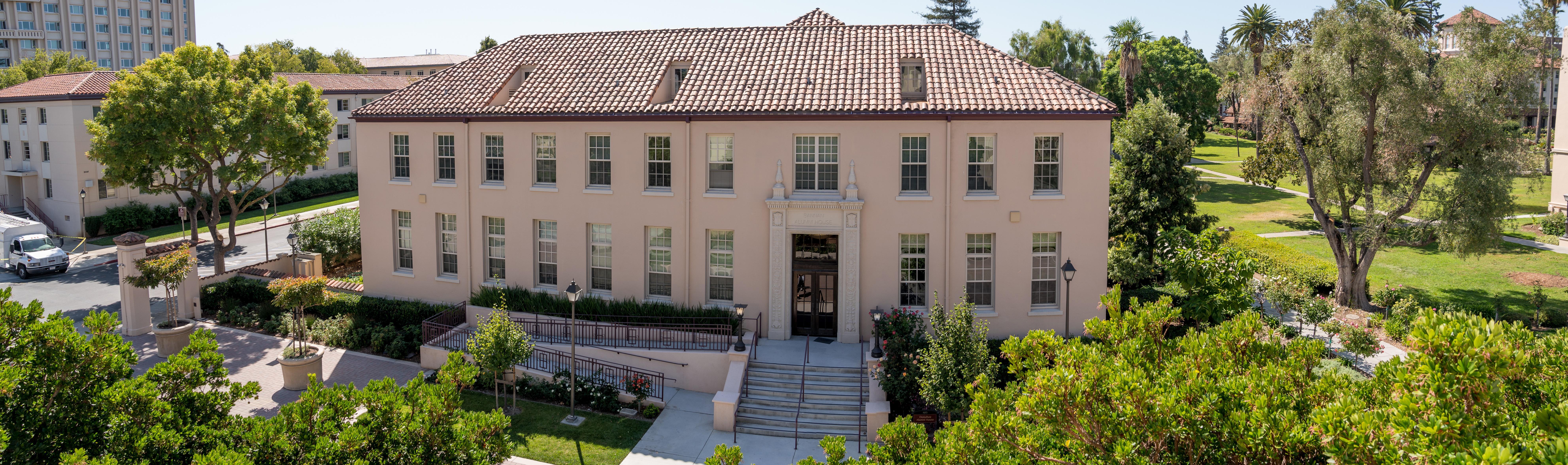 Exterior view of Bannan Alumni House entrance with lamps and steps