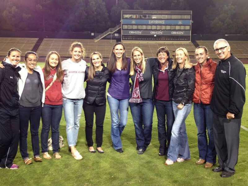 Group of people posing on soccer field during Alumni Night at Womens Soccer vs USD.