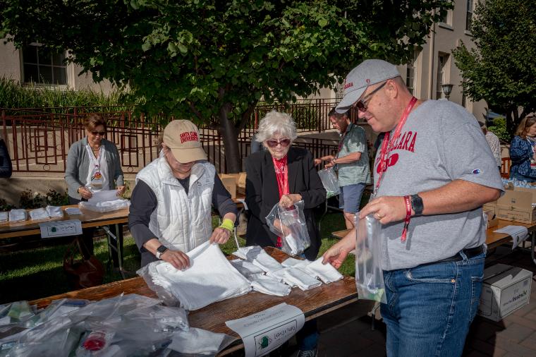 Several people at a table packing hygiene kits for community service project