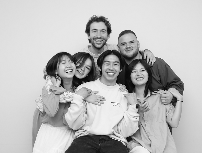 Group of people crowded together hugging for the camera