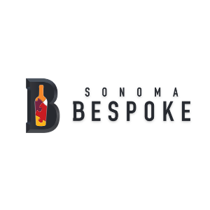 A wine bottle forms the inside of the letter b and is made of puzzle pieces. Next to the letter are the words Sonoma Bespoke 