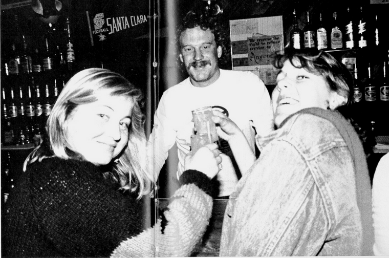 Three people smiling and laughing in 1984 Hut.