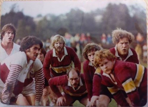 A group of rugby players preparing for a scrum. Hut Rob Adams 79.