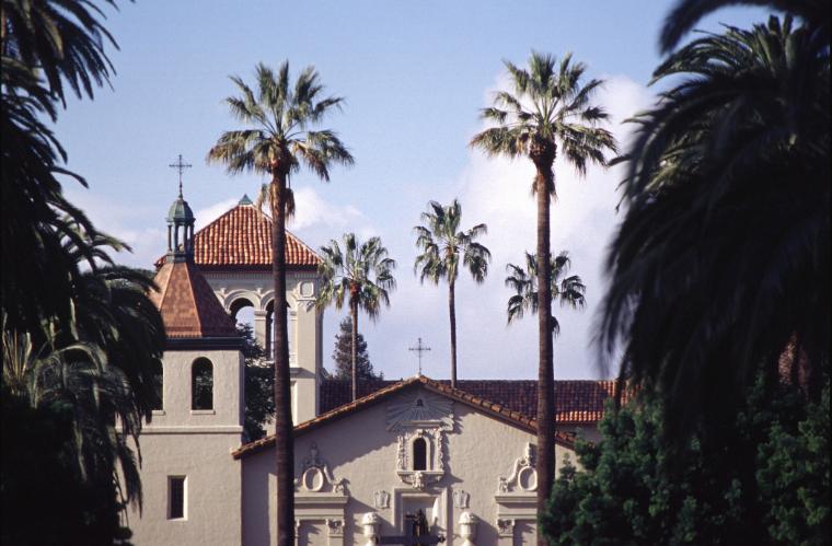 Mission church with palm trees in the background.