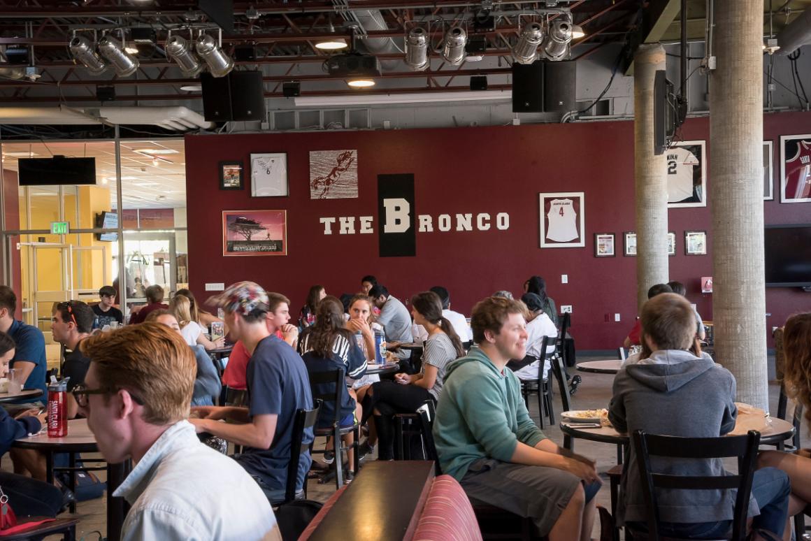 People sitting in a dining area at The Bronco 3 restaurant.