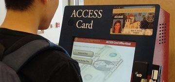 A person looking at a sign that reads ACCESS Office.