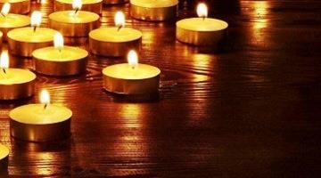 Lit candles on a wooden surface.