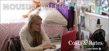 Two women working at desks in a housing office.