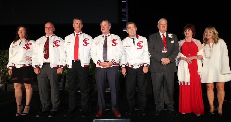 A group of people standing together on a stage at HOF 2018.