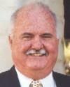 A smiling man in a suit.
