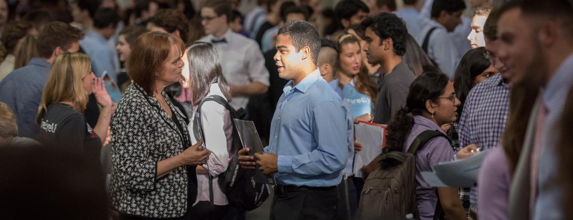 People gather in a crowded space, engaging and interacting.