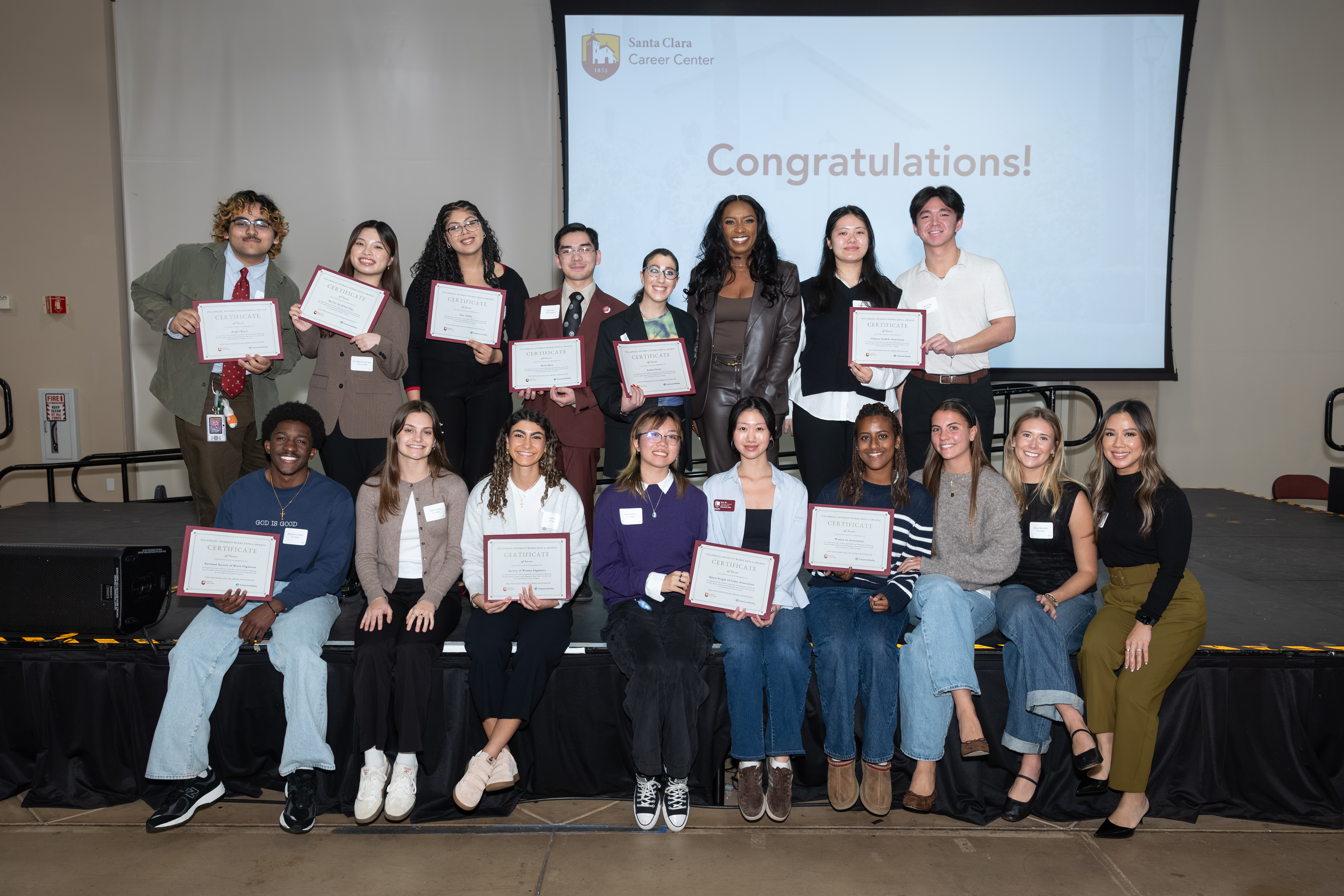Group of students holding award certificates