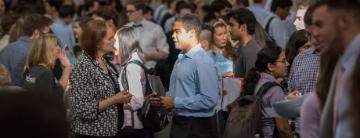 A man in a blue shirt stands out in a crowd.