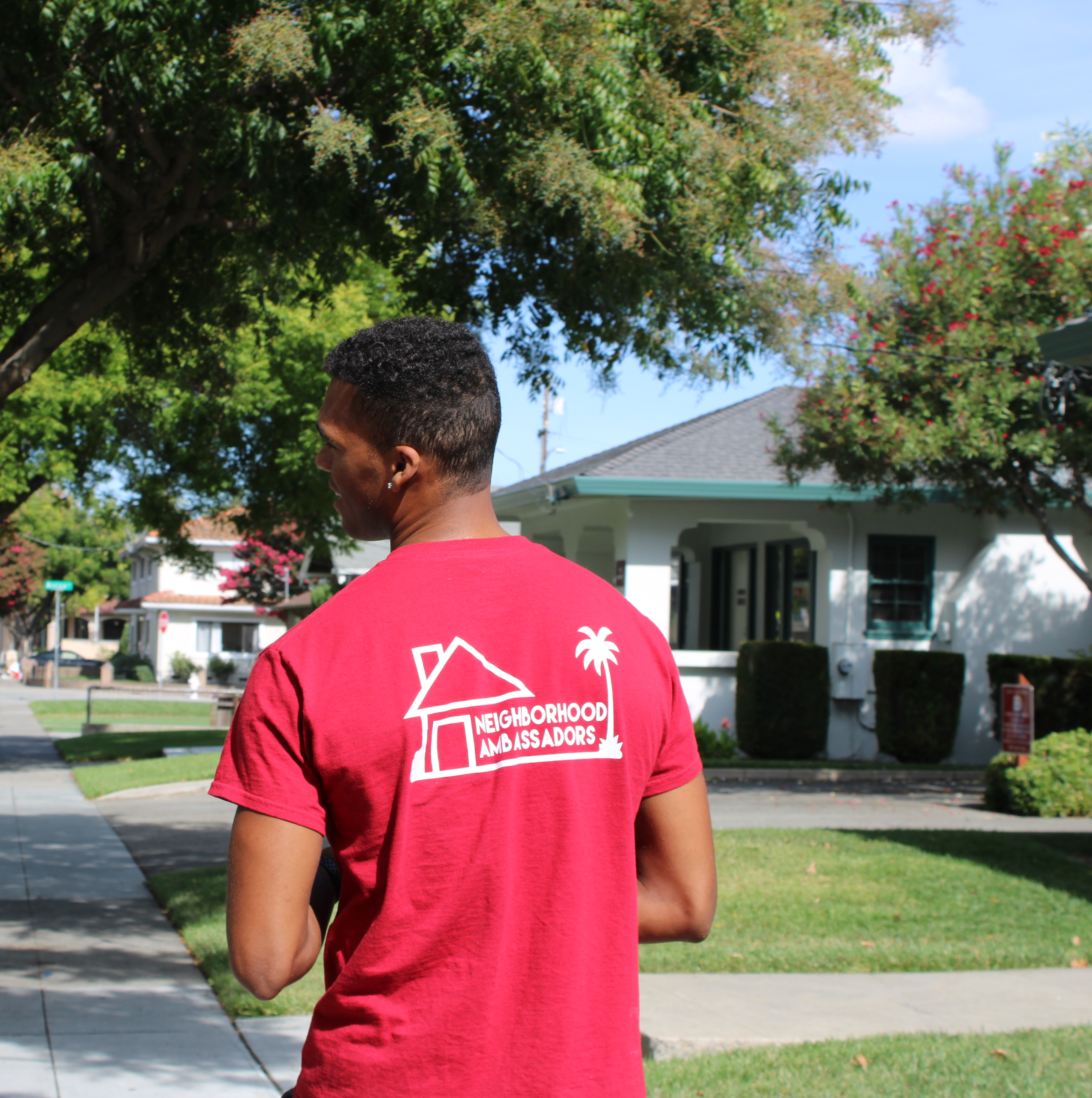 Backside view of Neighborhood Ambassador walking through the neighborhood