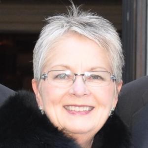 A person named Susan Carter smiling, wearing glasses.