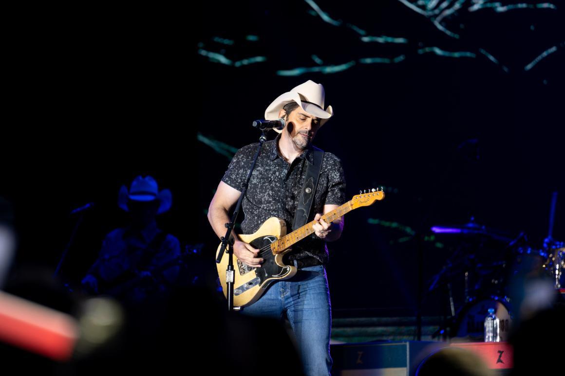 Musician Brad Paisley playing a guitar