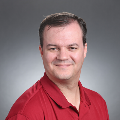 Headshot of a man in a red shirt.